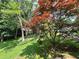 Lush backyard with mature trees, offering privacy and a serene view from the property at 602 Springharbor Dr, Woodstock, GA 30188
