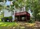 View of the backyard with a spacious deck, mature trees, and a well-maintained lawn, perfect for outdoor enjoyment at 602 Springharbor Dr, Woodstock, GA 30188