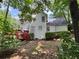 Exterior of the home highlighting the back deck, complemented by lush greenery and a private backyard setting at 602 Springharbor Dr, Woodstock, GA 30188