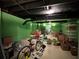 Basement area with green walls, carpeted floors, storage areas and bicycle at 602 Springharbor Dr, Woodstock, GA 30188