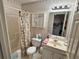Bathroom with floral wallpaper, shower and tub combo, sink and vanity at 602 Springharbor Dr, Woodstock, GA 30188