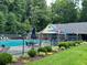 Inviting community pool area with ample seating and well-maintained landscaping for relaxation at 602 Springharbor Dr, Woodstock, GA 30188