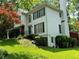 Charming home featuring a lush lawn, mature trees, and classic architectural design with green shutters at 602 Springharbor Dr, Woodstock, GA 30188
