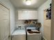 Laundry room with storage shelves, washer, and dryer at 602 Springharbor Dr, Woodstock, GA 30188