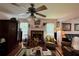 Living room featuring a fireplace, ceiling fan and area rug at 602 Springharbor Dr, Woodstock, GA 30188