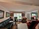 Cozy living room featuring ample seating, bright windows, and an open entryway to the dining area at 602 Springharbor Dr, Woodstock, GA 30188