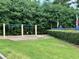 playground area featuring swings surrounded by lush greenery and well-maintained landscaping at 602 Springharbor Dr, Woodstock, GA 30188