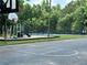 Outdoor recreation area including playground, tennis courts, and basketball court all set on a grassy lot at 602 Springharbor Dr, Woodstock, GA 30188