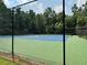 Well-maintained tennis courts surrounded by a secure fence, offering a great recreational amenity at 602 Springharbor Dr, Woodstock, GA 30188