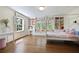 Bright bedroom features large windows, built-in bookshelves and window seat, and hardwood floors at 1011 W Paces Ferry Nw Rd, Atlanta, GA 30327