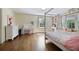 Bright bedroom features large windows, built-in bookshelves and window seat, and hardwood floors at 1011 W Paces Ferry Nw Rd, Atlanta, GA 30327