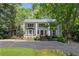 Elegant two-story white home featuring a meticulously maintained lawn and a circular driveway at 1011 W Paces Ferry Nw Rd, Atlanta, GA 30327