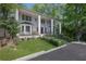 Beautiful two-story home with grand entrance, landscaped lawn, and mature trees at 1011 W Paces Ferry Nw Rd, Atlanta, GA 30327