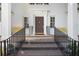 Close-up of front door with wrought iron railings, classic columns, and charming yellow benches at 1011 W Paces Ferry Nw Rd, Atlanta, GA 30327