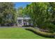 Charming two-story home with landscaped front yard, circular driveway, and lush, mature trees at 1011 W Paces Ferry Nw Rd, Atlanta, GA 30327