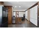 Kitchen area with wood cabinets and black appliances leading to an adjacent entertainment room at 1011 W Paces Ferry Nw Rd, Atlanta, GA 30327