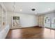 Bright living room with hardwood floors, built-in shelving and views of the backyard and pool at 1011 W Paces Ferry Nw Rd, Atlanta, GA 30327