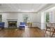 Bright living room featuring hardwood floors, fireplace, and large windows providing ample natural light at 1011 W Paces Ferry Nw Rd, Atlanta, GA 30327