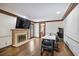 Open living area with fireplace, hardwood floors, and space for a large table and entertainment at 1011 W Paces Ferry Nw Rd, Atlanta, GA 30327