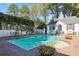 Backyard pool with brick patio, surrounded by lush greenery and privacy fence at 1011 W Paces Ferry Nw Rd, Atlanta, GA 30327