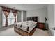 Cozy bedroom with carpet, a double bed with storage, and a window with decorative curtains at 4280 Azurite St, Cumming, GA 30040
