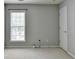An empty bedroom space with a large window providing natural light at 4280 Azurite St, Cumming, GA 30040