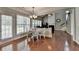 Inviting dining area bathed in natural light, with hardwood floors and views of the fireplace at 4280 Azurite St, Cumming, GA 30040