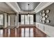 Elegant dining room with hardwood floors, decorative wainscoting, and stylish lighting at 4280 Azurite St, Cumming, GA 30040