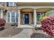 Inviting front entrance with stone accents, white columns, and a beautifully landscaped yard at 4280 Azurite St, Cumming, GA 30040