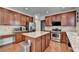 Well-lit kitchen features stainless steel appliances, wooden cabinets, granite countertops, and a center island at 4280 Azurite St, Cumming, GA 30040