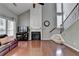 Inviting living room features hardwood floors, a cozy fireplace, and staircase at 4280 Azurite St, Cumming, GA 30040