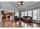 Bright living room with hardwood floors, large windows, and an open layout to the kitchen at 4280 Azurite St, Cumming, GA 30040
