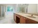 Well-lit bathroom featuring double vanity, soaking tub, and separate glass-enclosed shower at 429 Gold Xing, Canton, GA 30114