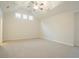 Spacious bedroom featuring vaulted ceiling with fan, carpet flooring, and three windows at 429 Gold Xing, Canton, GA 30114