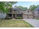 Charming two-story home boasts a manicured lawn, covered porch, and a two-car garage at 429 Gold Xing, Canton, GA 30114