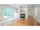 Open living room with hardwood floors, a fireplace, and a large window overlooking a deck at 429 Gold Xing, Canton, GA 30114
