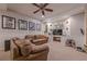 Relaxing basement featuring comfortable leather couches, carpeted floors, and a large TV at 745 Amberton Close, Suwanee, GA 30024
