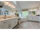 This luxurious bathroom features a large soaking tub, dual vanities, and stylish decor at 745 Amberton Close, Suwanee, GA 30024