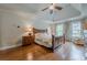 This spacious bedroom features a large window, hardwood floors, and a ceiling fan at 745 Amberton Close, Suwanee, GA 30024