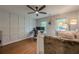 The bedroom has hardwood floors, large windows, and a ceiling fan for added comfort and style at 745 Amberton Close, Suwanee, GA 30024