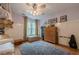 Well-lit bedroom includes a bunk bed, window with natural light, and wood flooring at 745 Amberton Close, Suwanee, GA 30024