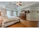 This spacious bedroom features a tray ceiling, hardwood floors, and abundant natural light from the large windows at 745 Amberton Close, Suwanee, GA 30024