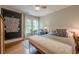 Relaxing bedroom with a large chalkboard wall, plush bedding, and bright natural light at 745 Amberton Close, Suwanee, GA 30024