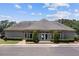 Community clubhouse exterior with manicured landscaping, sidewalk and parking spaces at 745 Amberton Close, Suwanee, GA 30024