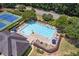 Aerial view of the community pool area featuring a pool, tennis courts and lounge chairs at 745 Amberton Close, Suwanee, GA 30024