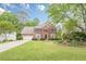 Beautiful two-story brick home with a lush green lawn and meticulously maintained landscaping at 745 Amberton Close, Suwanee, GA 30024
