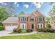 Attractive brick house with tidy landscaping, and a well-kept lawn at 745 Amberton Close, Suwanee, GA 30024