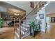 Inviting foyer with hardwood floors, elegant staircase, and view into adjacent rooms at 745 Amberton Close, Suwanee, GA 30024