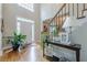 Welcoming foyer with gleaming hardwood floors and an elegant staircase leading to the upper level at 745 Amberton Close, Suwanee, GA 30024