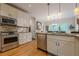 Bright kitchen features stainless steel appliances, granite counters, and hardwood flooring at 745 Amberton Close, Suwanee, GA 30024